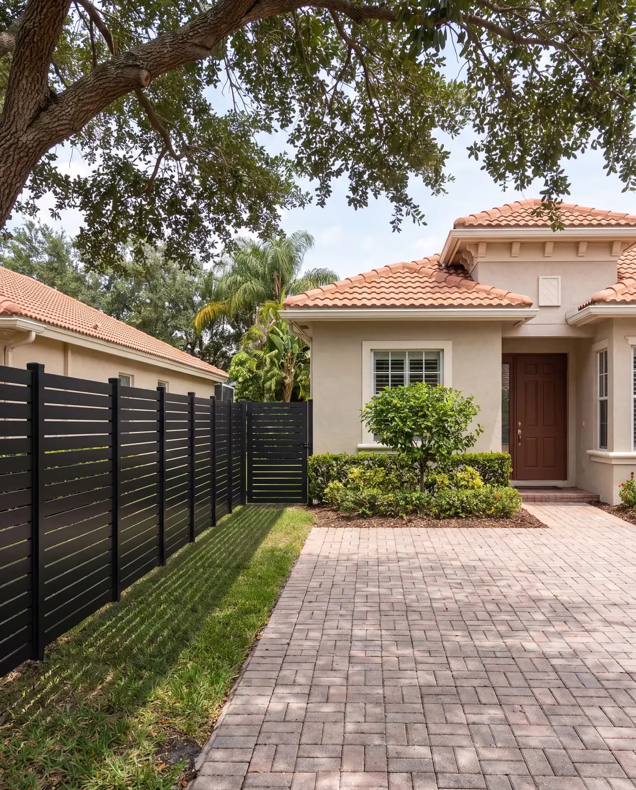 Black horizontal aluminum fence along a front yard