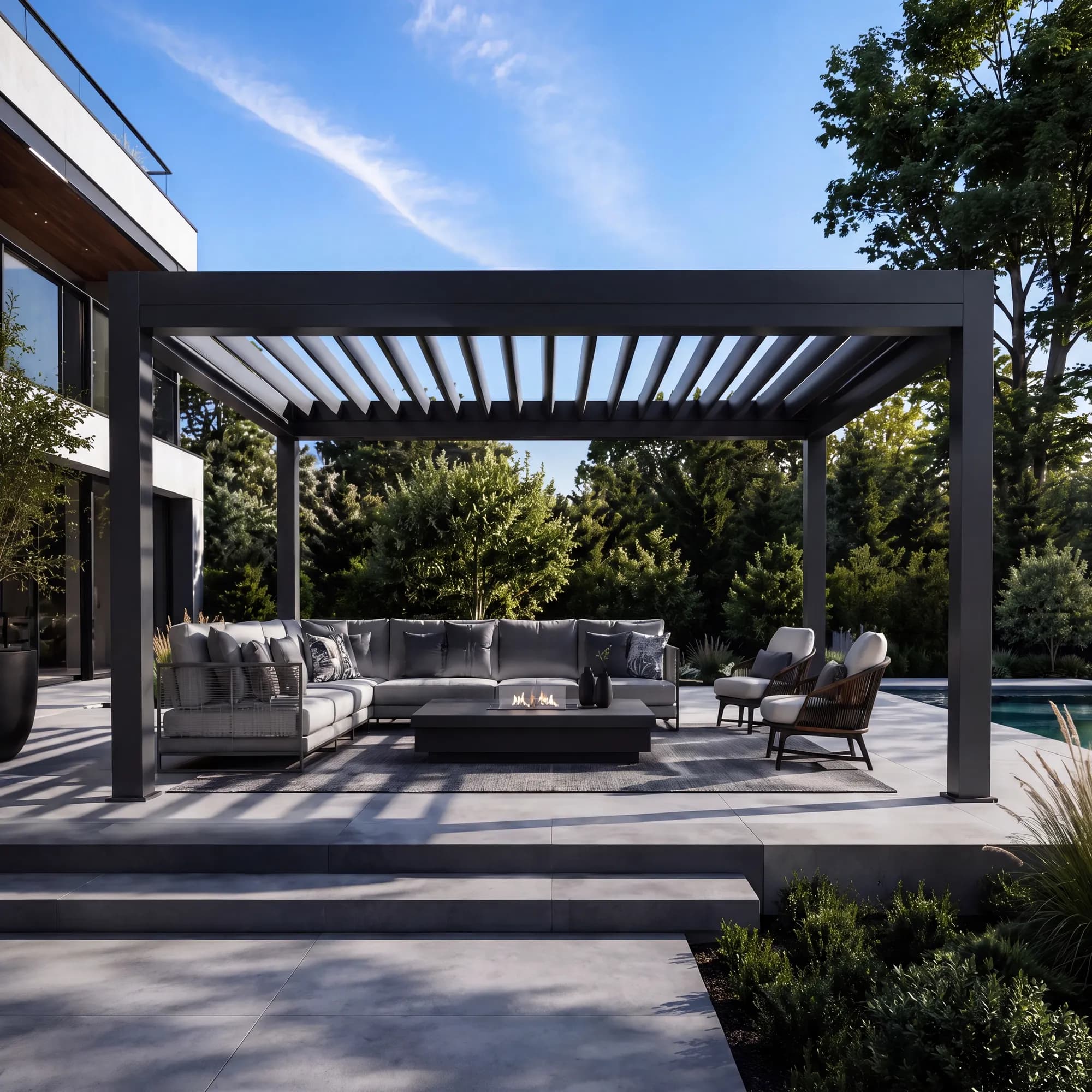 Black louvered aluminum pergola over a patio lounge