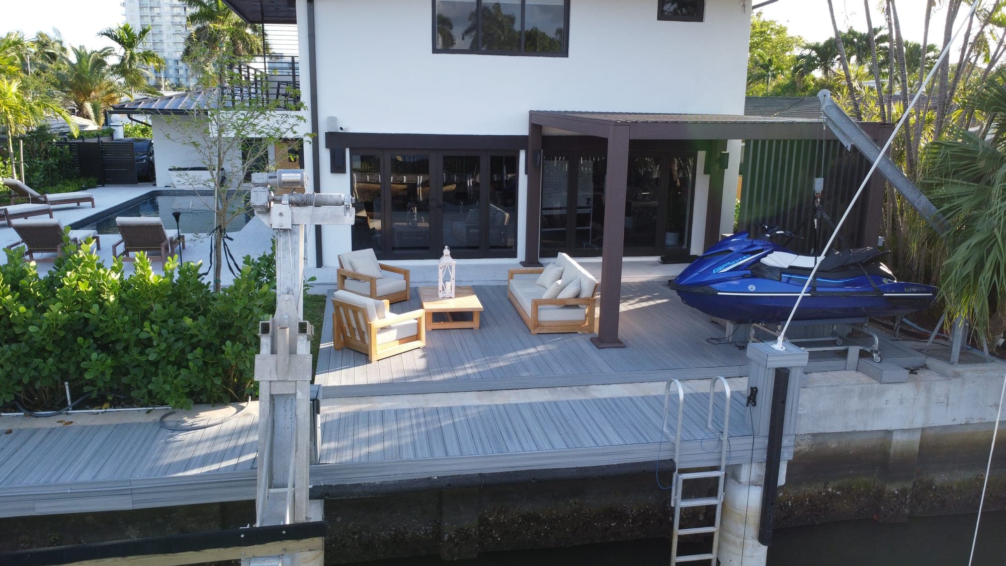 Grey WPC decking on a waterfront dock and patio with a brown WPC pergola