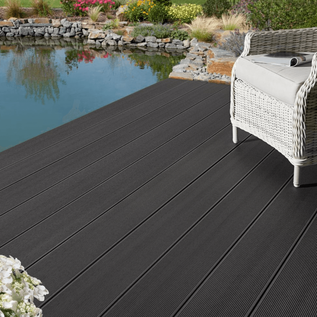 Dark grey WPC decking beside pond with outdoor seating
