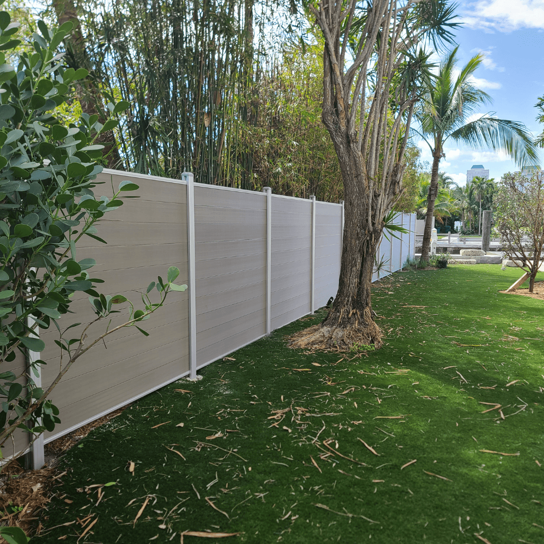 Beige WPC fence Miami backyard with turf