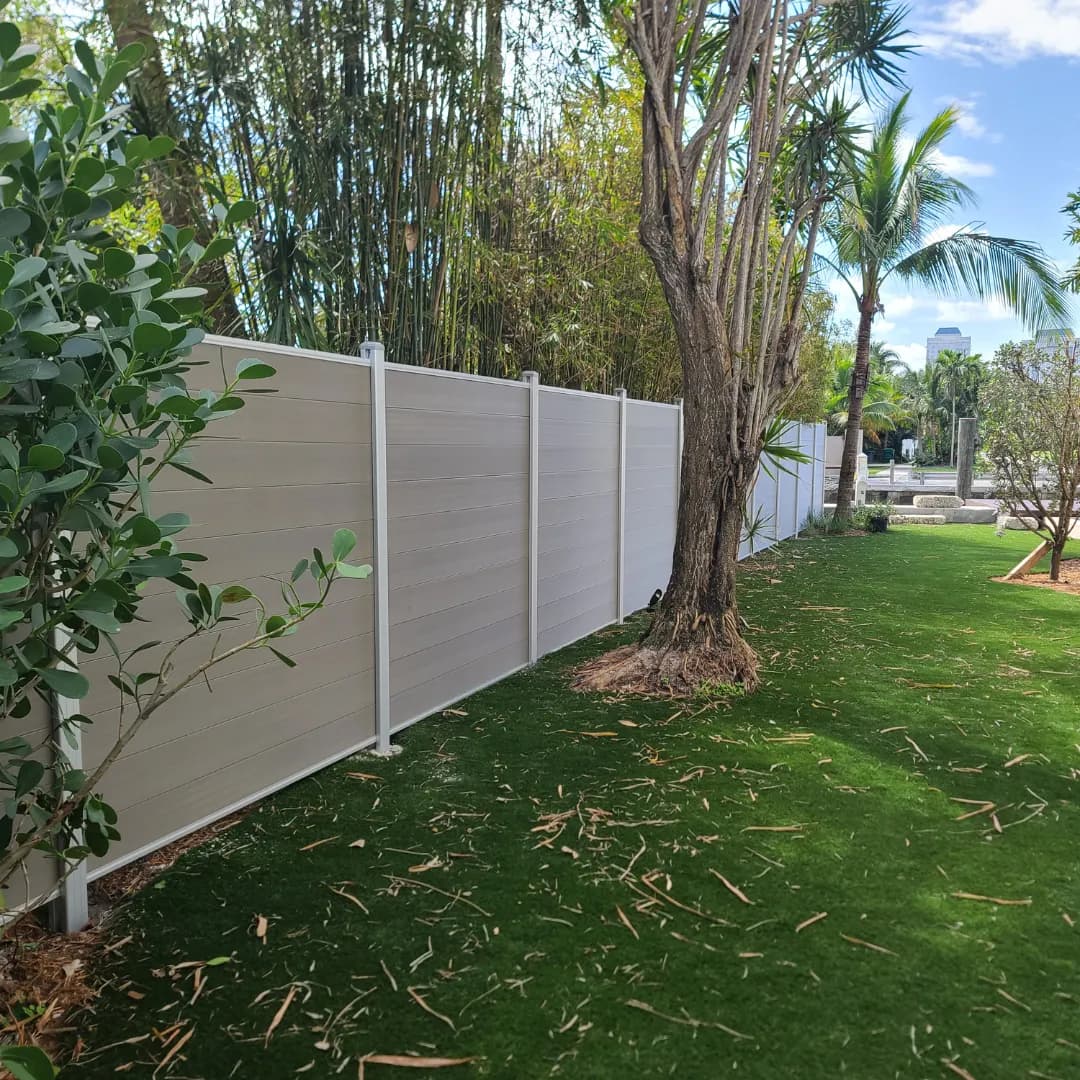 antique driftwood WPC composite fence in a Miami-Dade backyard with tropical landscaping