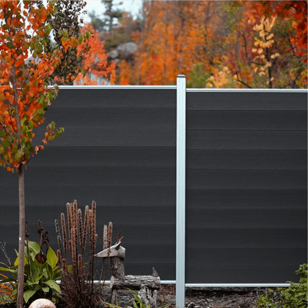 Dark grey WPC composite fence with autumn garden