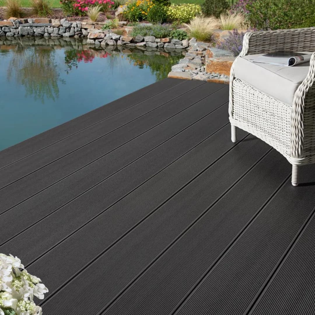 Dark grey WPC decking beside a pond